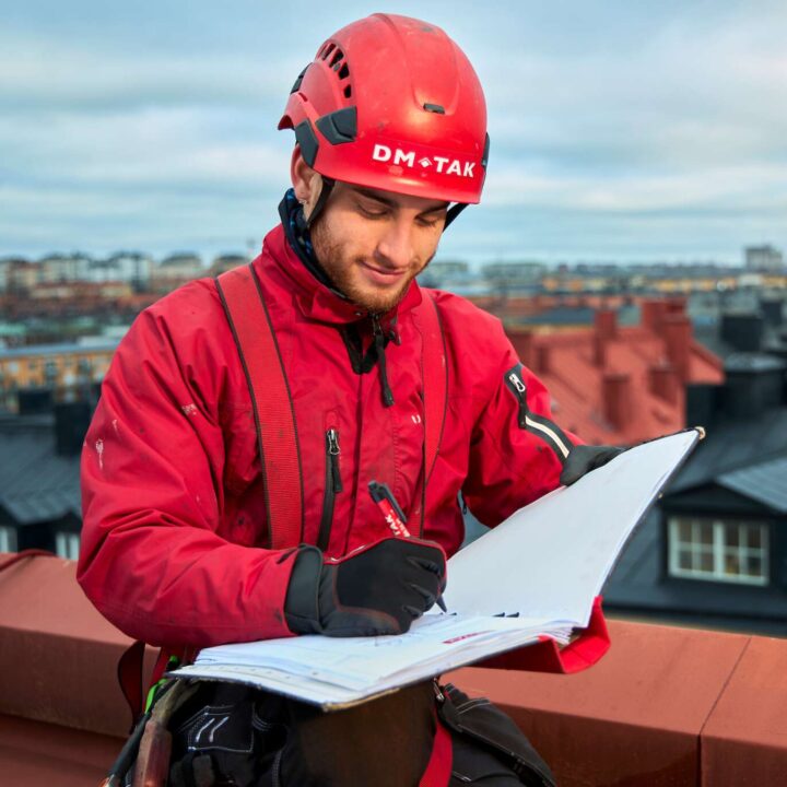 En takarbetare som fyller i en checklista